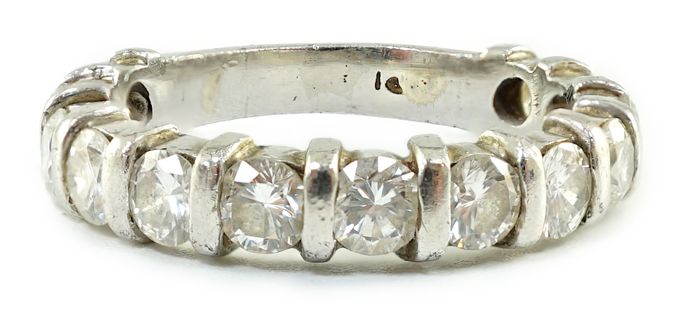 An 18ct white gold and thirteen stone round brilliant cut diamond set three quarter eternity ring